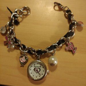 Betseyville wristwatch in charm bracelet style. Silver in tone and 6 charms.